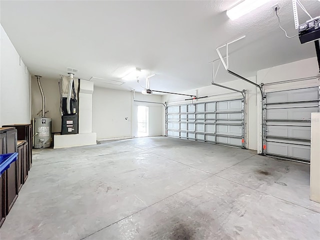garage with heating unit, a garage door opener, and electric water heater