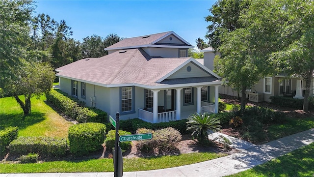 bungalow featuring stucco siding, roof with shingles, and covered porch