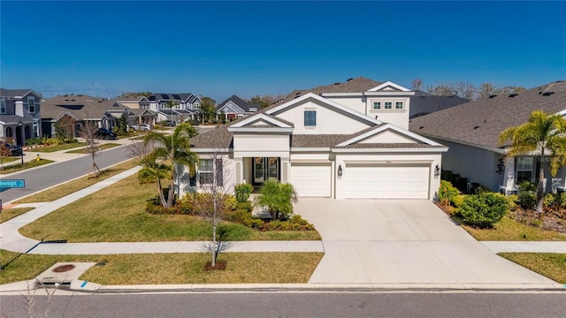 traditional home featuring concrete driveway, a residential view, stucco siding, an attached garage, and a front lawn