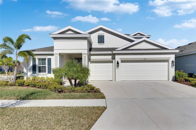 view of front of property with concrete driveway and stucco siding