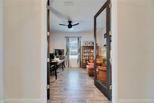 office featuring visible vents, a ceiling fan, and wood finish floors