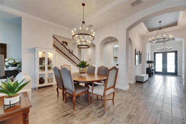 dining room featuring visible vents, wood finish floors, and a notable chandelier