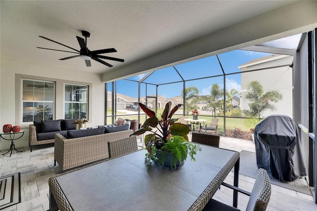 view of patio / terrace featuring outdoor lounge area, ceiling fan, outdoor dining area, and glass enclosure