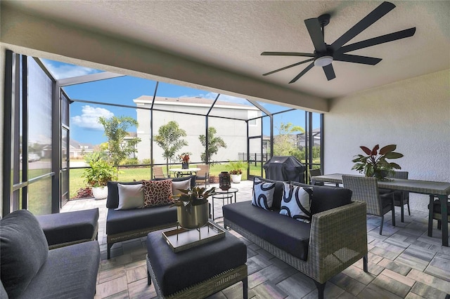view of patio featuring grilling area, a ceiling fan, an outdoor hangout area, and a lanai