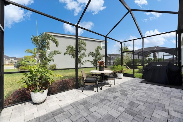 view of patio / terrace featuring area for grilling and glass enclosure