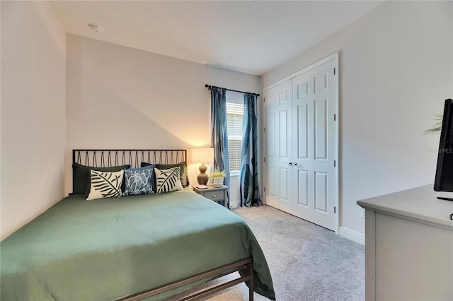 bedroom featuring a closet, carpet flooring, and baseboards