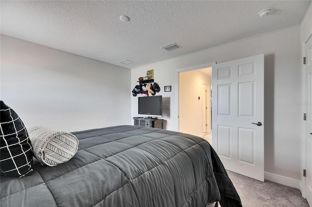 carpeted bedroom with visible vents, a textured ceiling, and baseboards