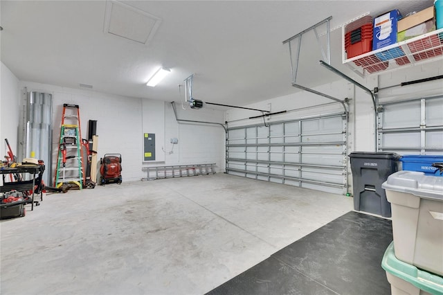 garage featuring a garage door opener and electric panel