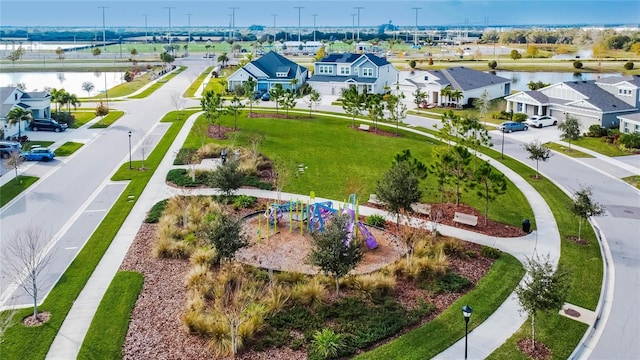 bird's eye view featuring a water view and a residential view