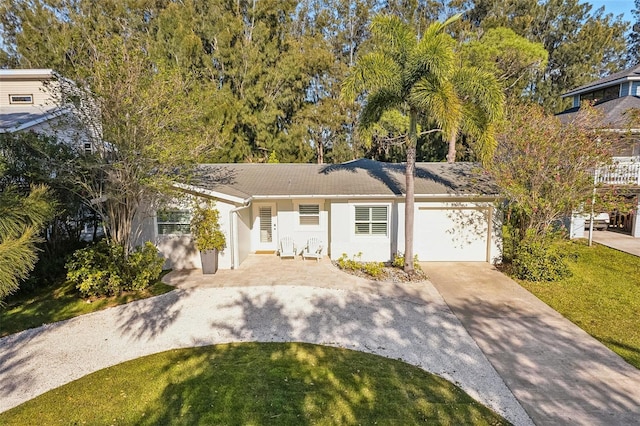 1908 Sutherland Dr W, Palm Harbor, FL 34683 - ranch-style house featuring concrete driveway, stucco siding, a garage, and a front lawn
