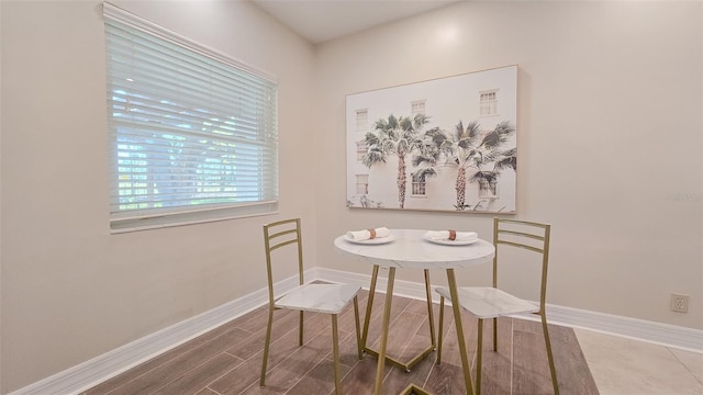 dining room with baseboards and wood finished floors