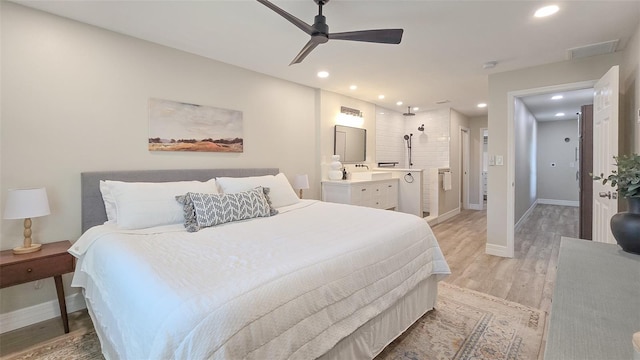 bedroom featuring recessed lighting, baseboards, light wood finished floors, and connected bathroom