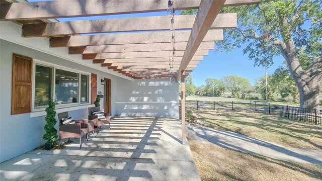 view of patio featuring a pergola and fence