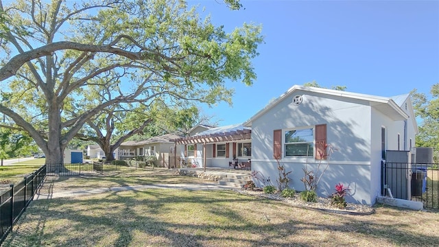 view of front facade featuring a patio, a pergola, a front yard, and fence