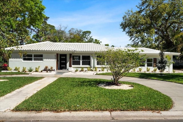 6531 2nd Ave N, Saint Petersburg, FL 33710 - ranch-style house featuring a tile roof, stucco siding, and a front lawn
