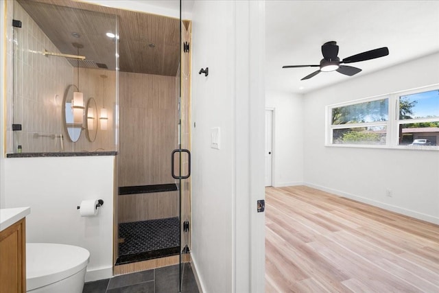 6531 2nd Ave N, Saint Petersburg, FL 33710 - full bathroom with vanity, baseboards, a stall shower, a ceiling fan, and toilet