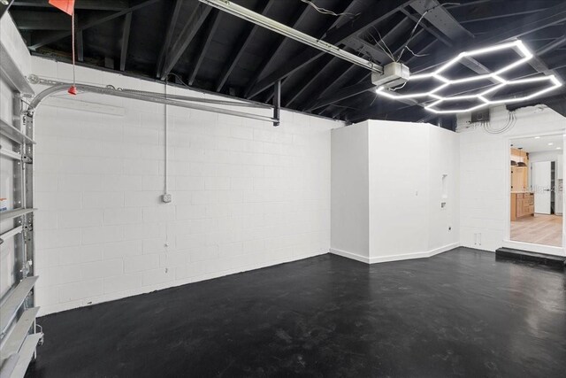6531 2nd Ave N, Saint Petersburg, FL 33710 - garage with a garage door opener and concrete block wall