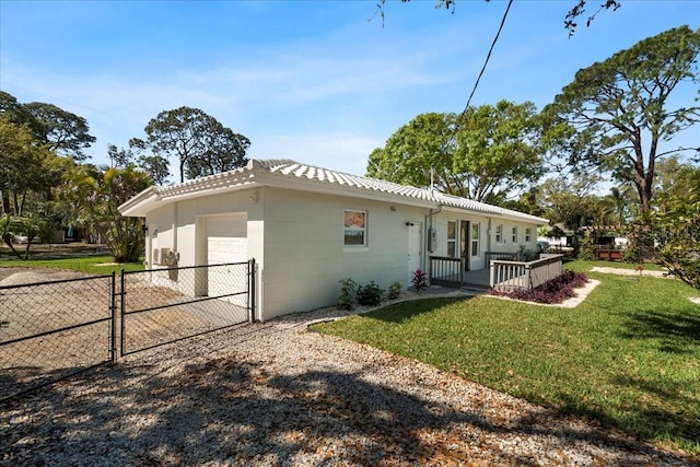 6531 2nd Ave N, Saint Petersburg, FL 33710 - exterior space featuring a front yard, fence, a gate, an attached garage, and driveway