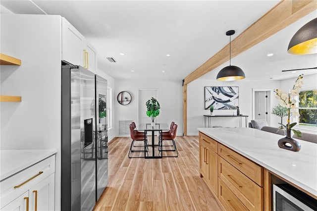 6531 2nd Ave N, Saint Petersburg, FL 33710 - kitchen featuring visible vents, white cabinets, hanging light fixtures, light wood finished floors, and stainless steel appliances