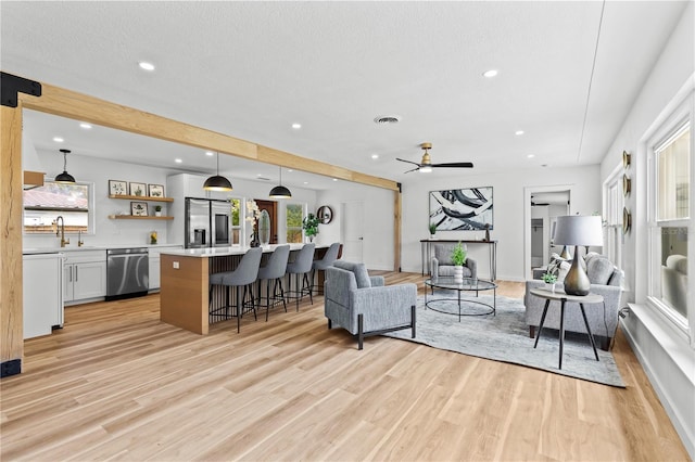 6531 2nd Ave N, Saint Petersburg, FL 33710 - living room with light wood-style flooring, bar area, visible vents, recessed lighting, and a ceiling fan