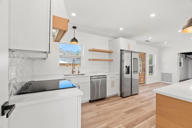6531 2nd Ave N, Saint Petersburg, FL 33710 - kitchen featuring light wood-style flooring, a sink, recessed lighting, and appliances with stainless steel finishes