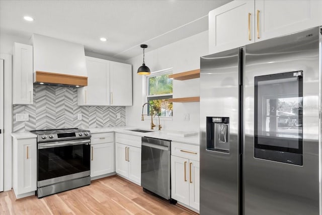 6531 2nd Ave N, Saint Petersburg, FL 33710 - kitchen with premium range hood, appliances with stainless steel finishes, a sink, and white cabinets