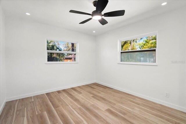 6531 2nd Ave N, Saint Petersburg, FL 33710 - empty room with baseboards, a healthy amount of sunlight, light wood finished floors, and recessed lighting