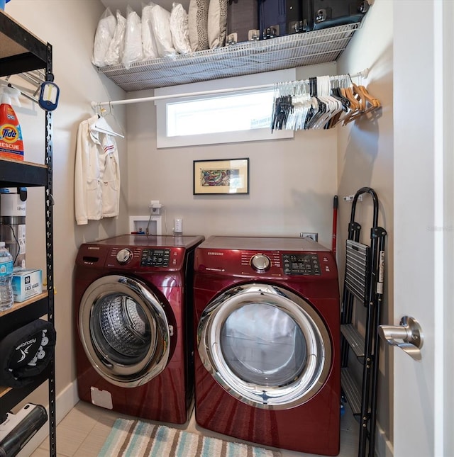clothes washing area with laundry area, tile patterned floors, and washing machine and clothes dryer