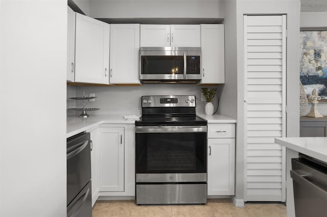 6923 Stones Throw Cir N Unit 4205, Saint Petersburg, FL 33710 - kitchen with appliances with stainless steel finishes, white cabinetry, and light countertops