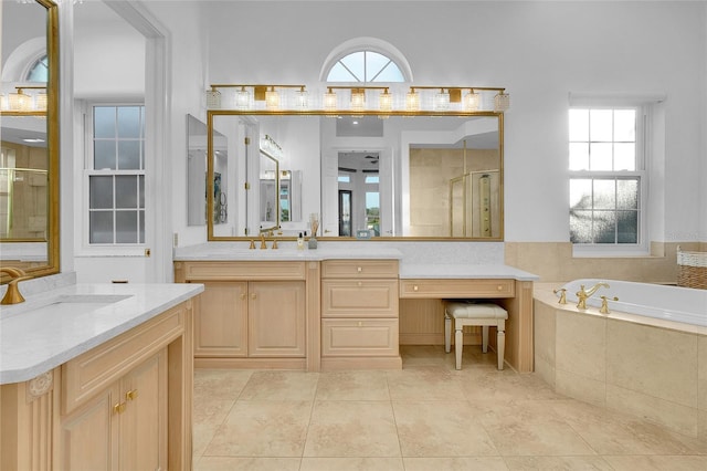 6113 Pasadena Point Blvd, Gulfport, FL 33707 - bathroom featuring two vanities, a bath, a shower stall, and plenty of natural light
