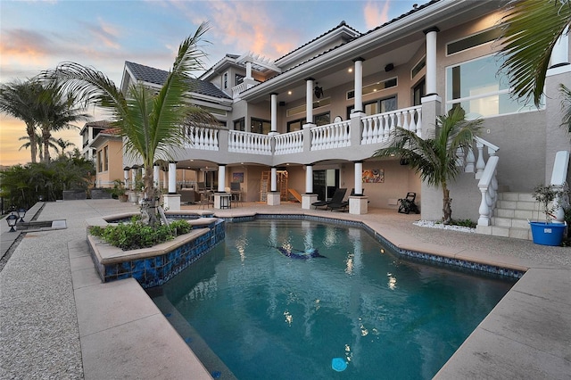 6113 Pasadena Point Blvd, Gulfport, FL 33707 - pool at dusk featuring a patio and a pool with connected hot tub