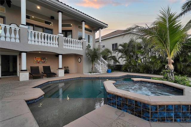 6113 Pasadena Point Blvd, Gulfport, FL 33707 - pool at dusk with an in-ground hot tub, an outdoor pool, a patio, and stairs