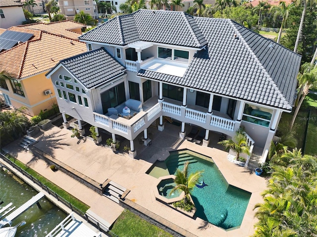 6113 Pasadena Point Blvd, Gulfport, FL 33707 - rear view of property featuring a tile roof, a patio, a balcony, stairs, and a pool with connected hot tub