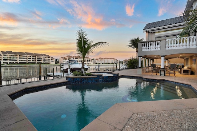 6113 Pasadena Point Blvd, Gulfport, FL 33707 - pool at dusk with a patio, boat lift, a pool with connected hot tub, a dock, and a water view
