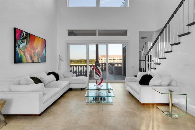 6113 Pasadena Point Blvd, Gulfport, FL 33707 - tiled living room with a towering ceiling and stairs