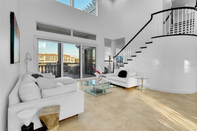 6113 Pasadena Point Blvd, Gulfport, FL 33707 - tiled living area with a towering ceiling and stairway