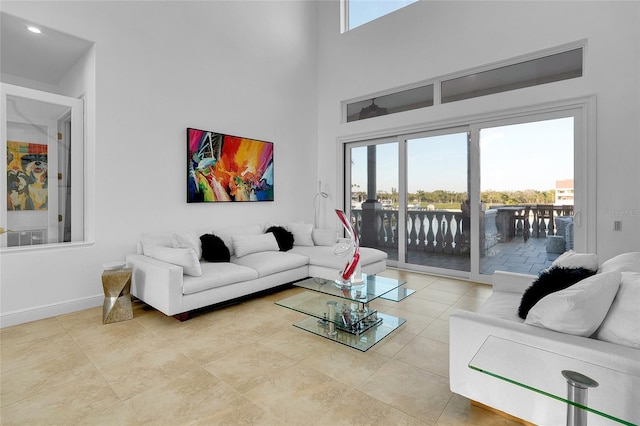 6113 Pasadena Point Blvd, Gulfport, FL 33707 - living room with healthy amount of natural light, a towering ceiling, and light tile patterned floors