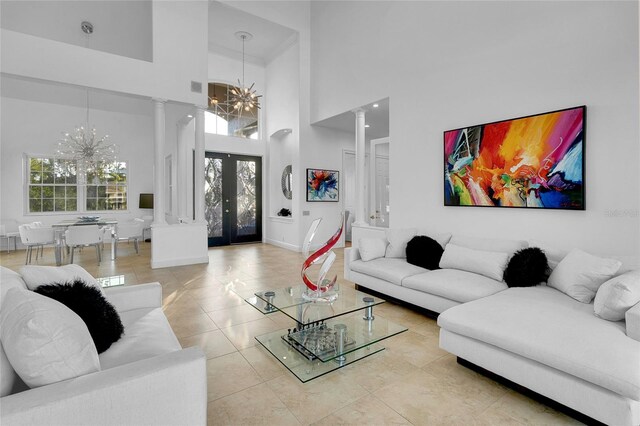 6113 Pasadena Point Blvd, Gulfport, FL 33707 - tiled living area featuring ornate columns, a chandelier, and a towering ceiling