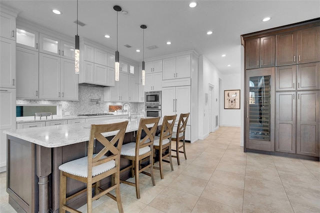 6113 Pasadena Point Blvd, Gulfport, FL 33707 - kitchen featuring built in appliances, decorative backsplash, recessed lighting, light tile patterned flooring, and light stone counters