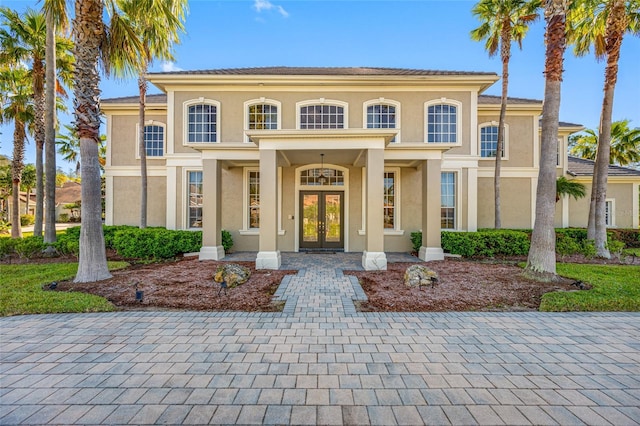 view of front facade with french doors and stucco siding