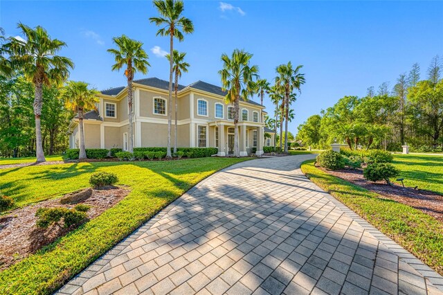 view of front of home featuring stucco siding and a front yard