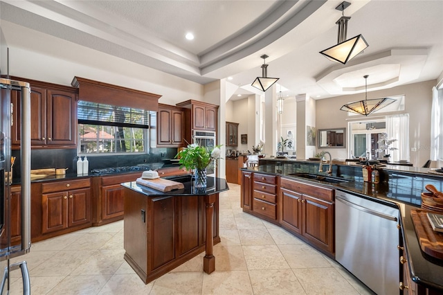 19005 Cour Ests, Lutz, FL 33558 - kitchen with appliances with stainless steel finishes, a sink, a tray ceiling, pendant lighting, and recessed lighting