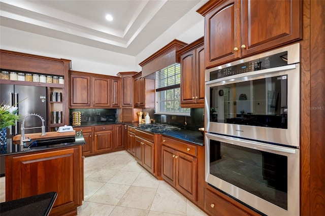 19005 Cour Ests, Lutz, FL 33558 - kitchen featuring appliances with stainless steel finishes, a sink, decorative backsplash, recessed lighting, and a kitchen island with sink