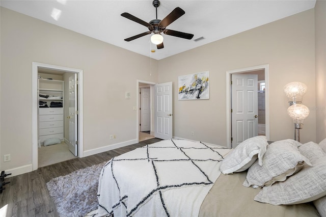 19005 Cour Ests, Lutz, FL 33558 - bedroom featuring wood finished floors, a spacious closet, baseboards, and connected bathroom