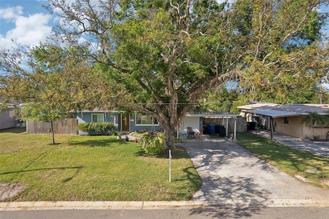 1901 66th Ave N, Saint Petersburg, FL 33702 - view of front of property with an attached carport, a front yard, and concrete driveway