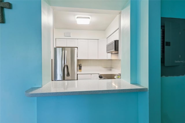 1901 66th Ave N, Saint Petersburg, FL 33702 - kitchen with appliances with stainless steel finishes, electric panel, light stone counters, and white cabinetry