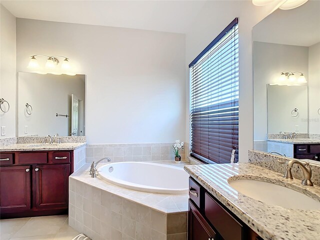 5235 SE 91st St, Ocala, FL 34480 - bathroom with tile patterned floors, two vanities, a garden tub, and a sink