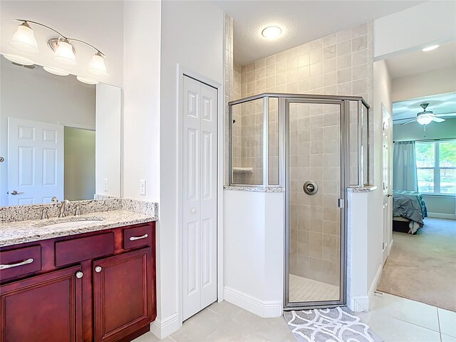 5235 SE 91st St, Ocala, FL 34480 - full bath featuring tile patterned floors, connected bathroom, a shower stall, and ceiling fan