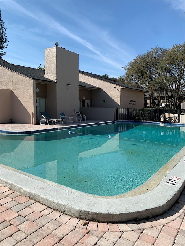 7526 Needle Leaf Pl Unit 30, Tampa, FL 33617 - community pool featuring a patio area and fence