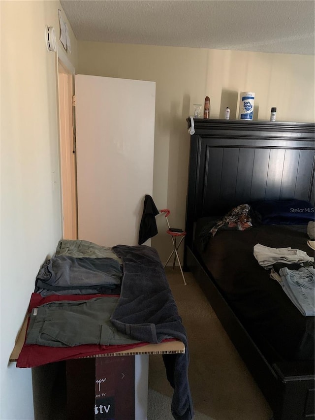 7526 Needle Leaf Pl Unit 30, Tampa, FL 33617 - bedroom with a textured ceiling and carpet floors